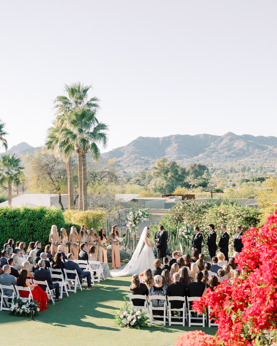 Couple exchanging vows in front of friends and family on our Paradise Views Wedding Lawn.