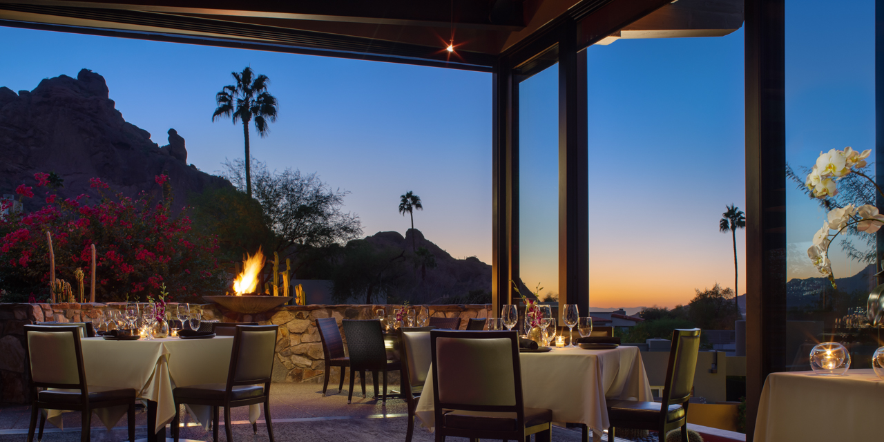 Praying Monk Dining room at dusk with outdoor firepit lit.