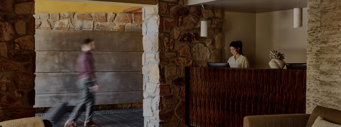 man walking in with suitcase