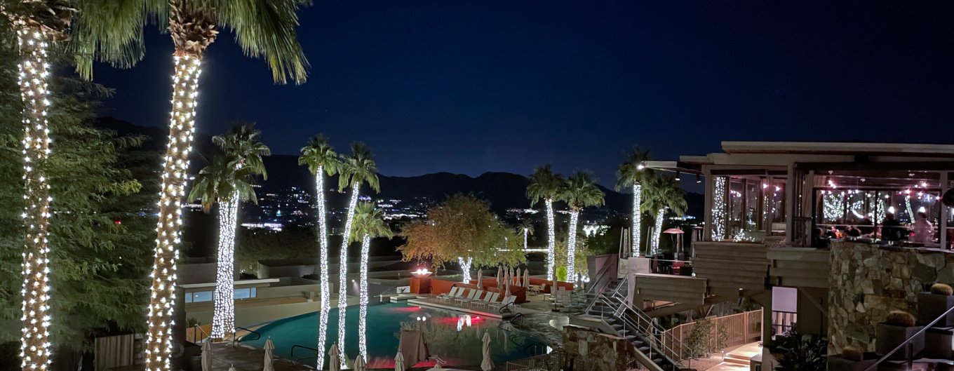 Night view of Infinity Pool and elements restaurant decorated with holiday lights.