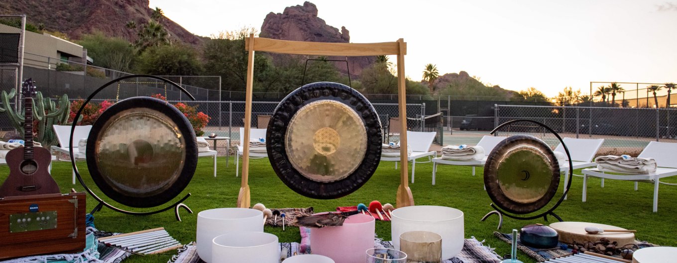 Sound Journey setup of symbols, harmonium, guitar and sound bowls.