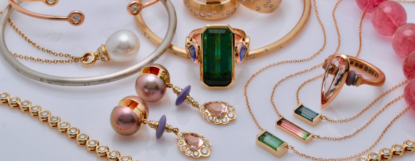 A display of custom earrings, bracelets, necklaces and rings from Raintree Jewelry.