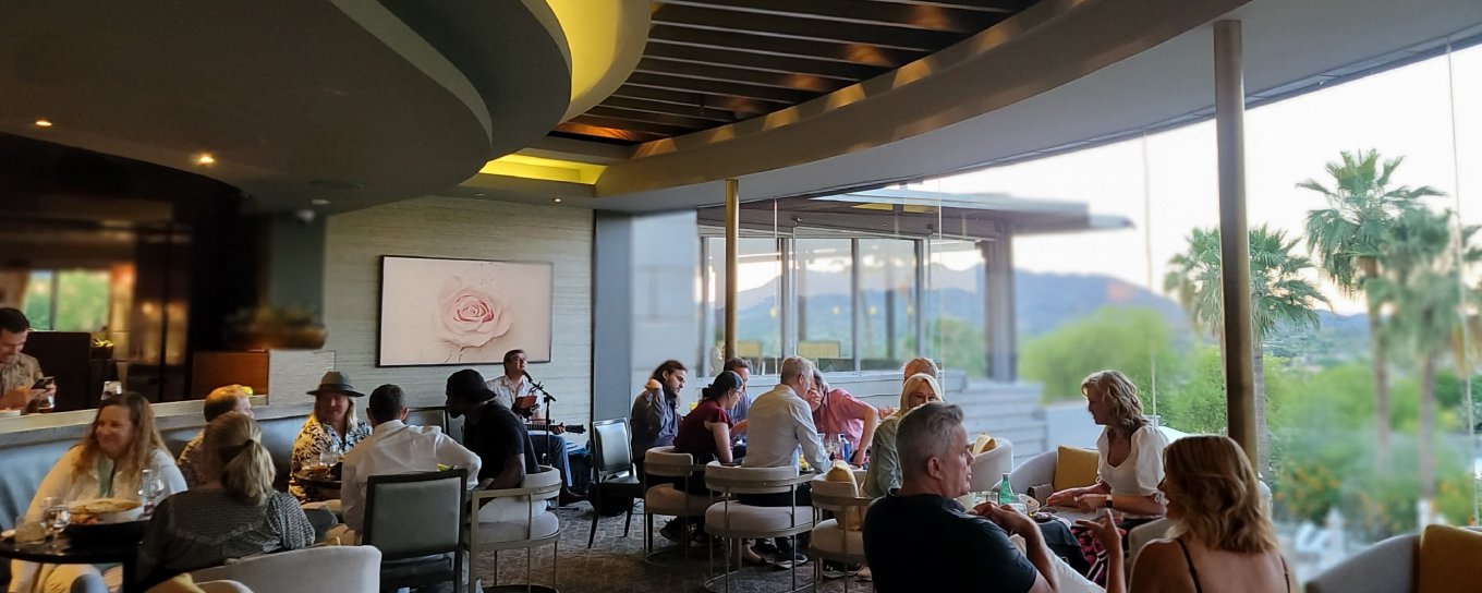 A musician performs to a seated crowd at Sanctuary's jade bar