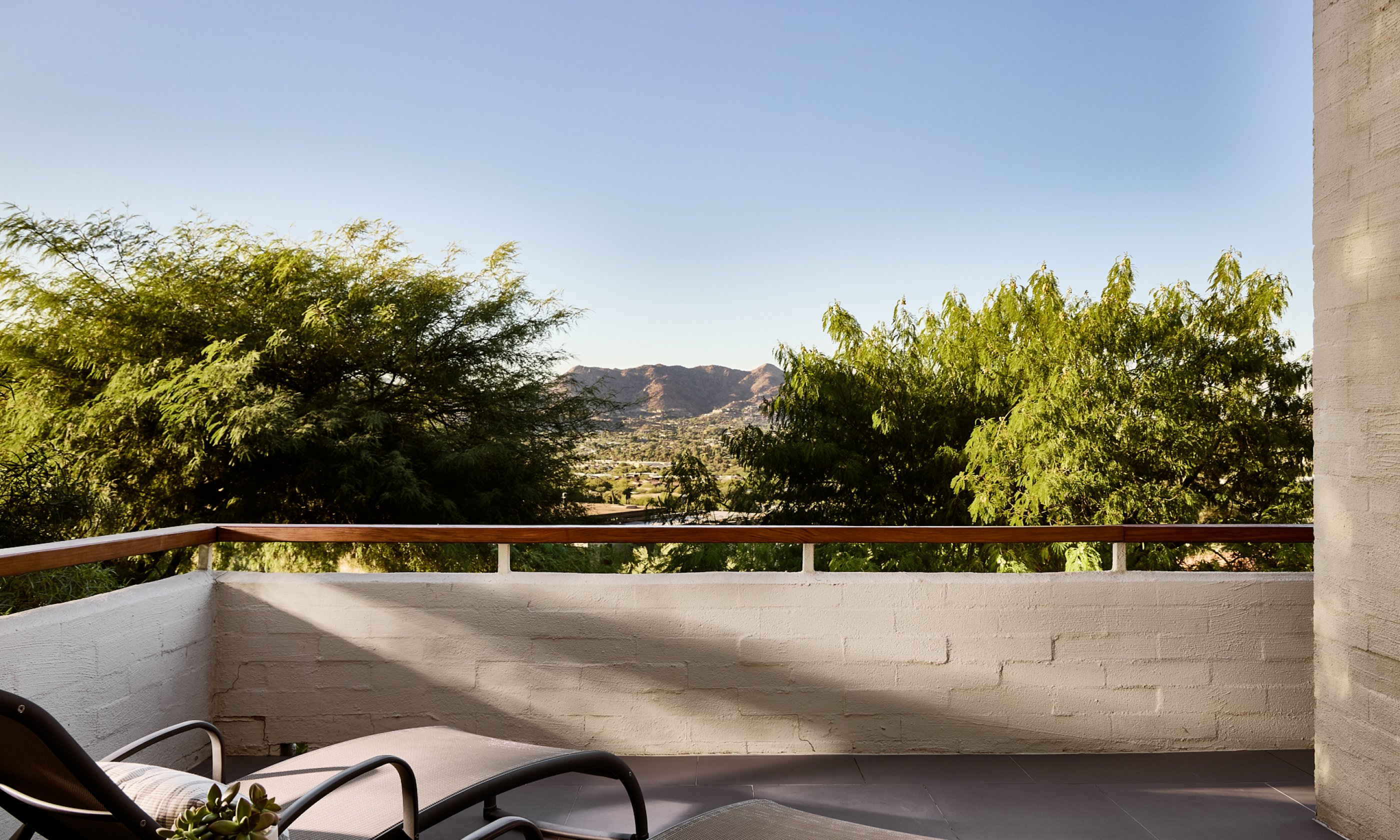 Patio with two lounge chairs and valley views.