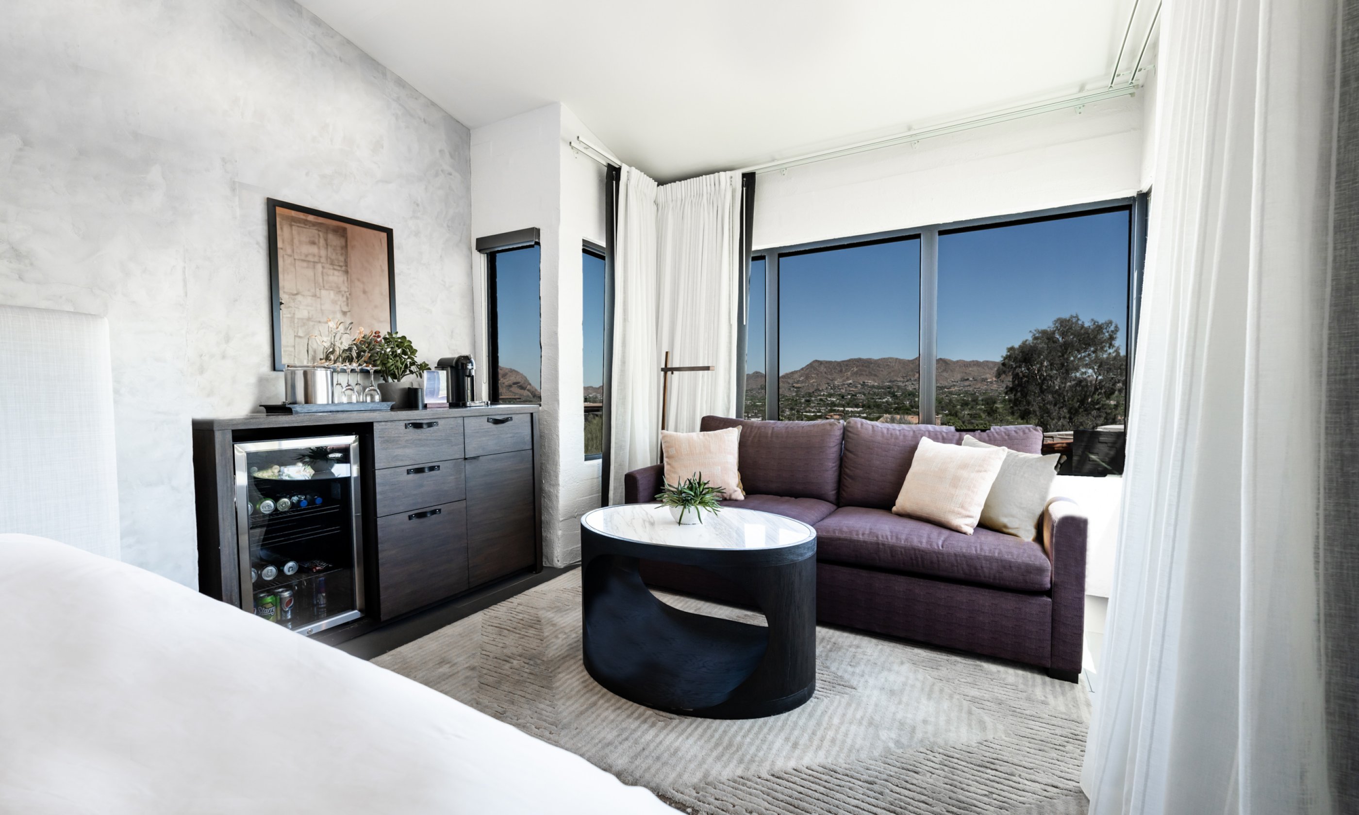 Camelback Casita seating area with comfortable couch, coffee table, fridge and dresser.