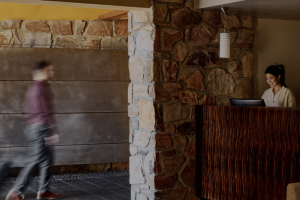 man walking in with suitcase 