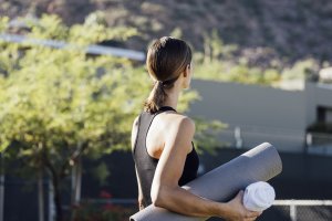Woman with yoga mat