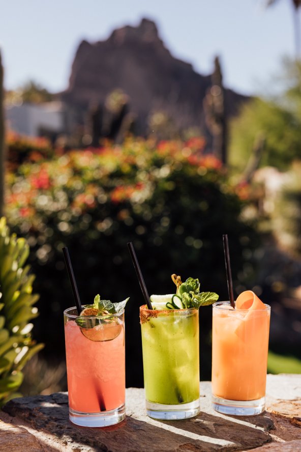 An assortment of summer cocktails with Praying Monk in background.