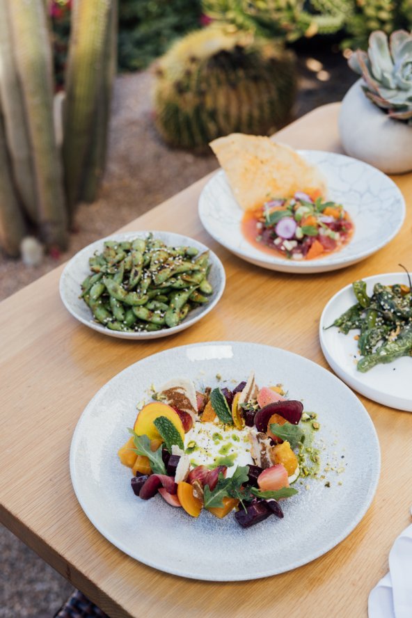 A collection of summer dishes served outside on Sanctuary's Paradise Views Patio.