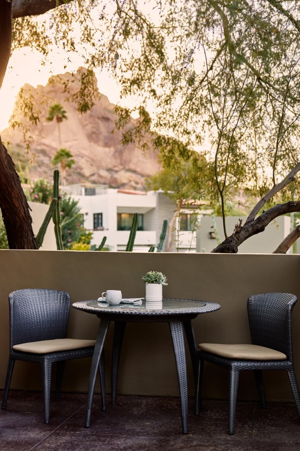 Spa Casita patio seating area with coffee cup and stunning sunset view of Praying Monk.