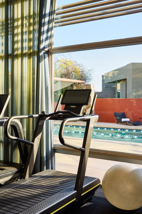 Sanctuary fitness center with treadmill and outdoor lap pool