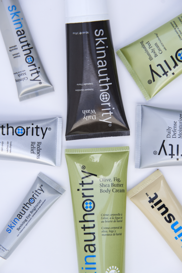 A colorful assortment of products from Skin Authority laid against a white background