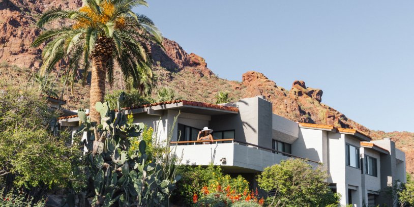 Woman enjoying view from Mountain Suite patio nestled on Camelback Mountain.