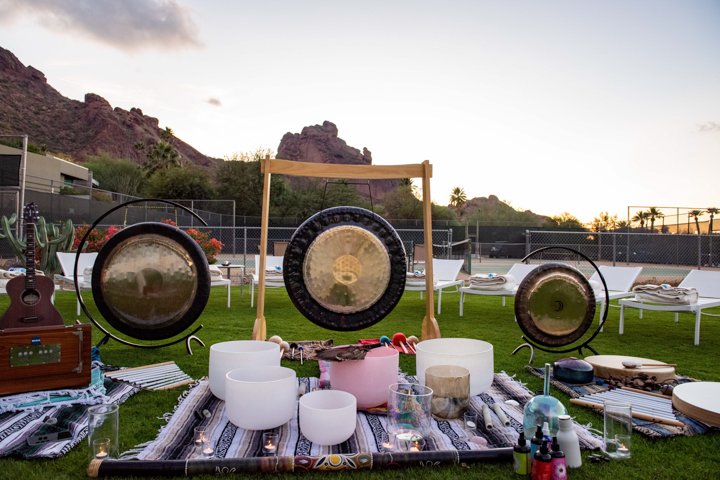 Sound journey setup on spa lawn with praying monk in background.
